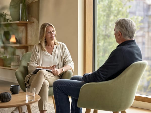 A one-to-one stress management session in a quiet, plant-filled room.